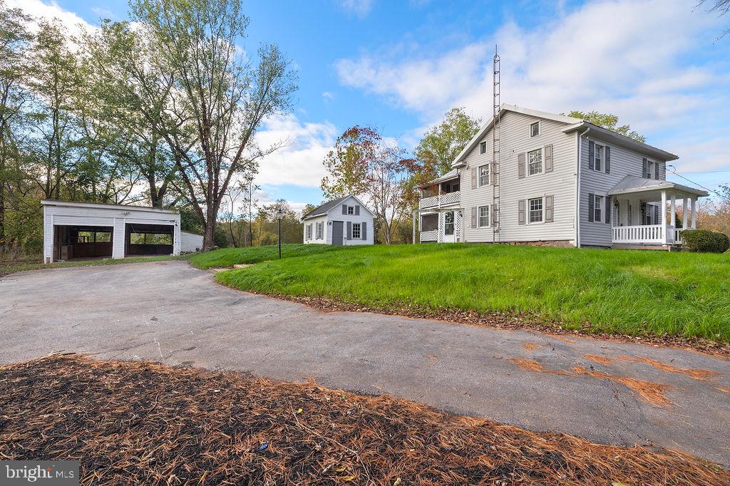 a front view of house with yard and green space