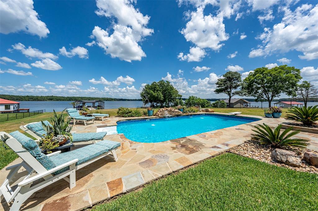 16241 Big Oak Bay Road Tyler, TX 75707 - Photo 33 of 40 In-ground swimming pool with flagstone surround, rock landscaping, and water feature