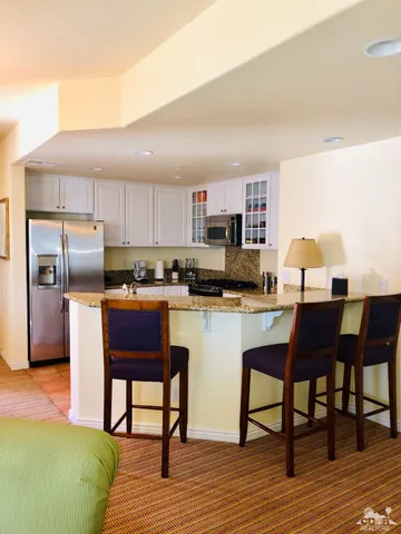 a kitchen with a sink cabinets and stainless steel appliances