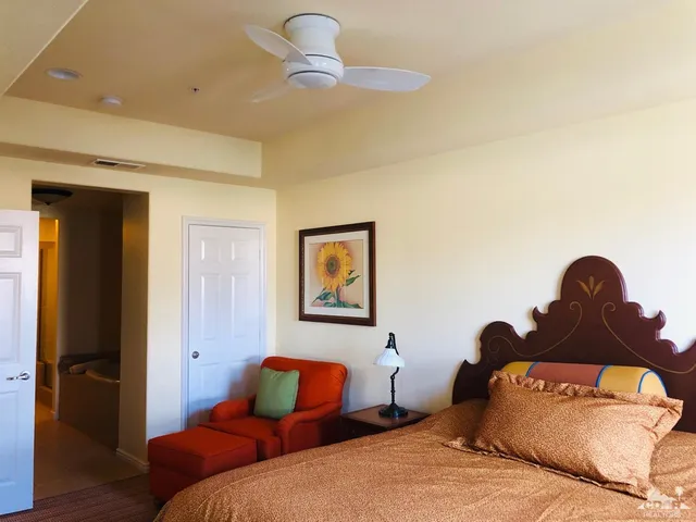 a bedroom with a bed and a painting on the wall