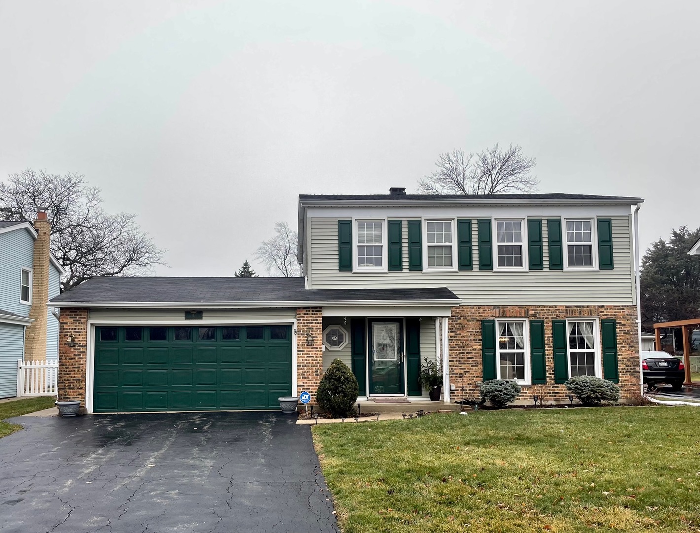 a front view of a brick house with a yard