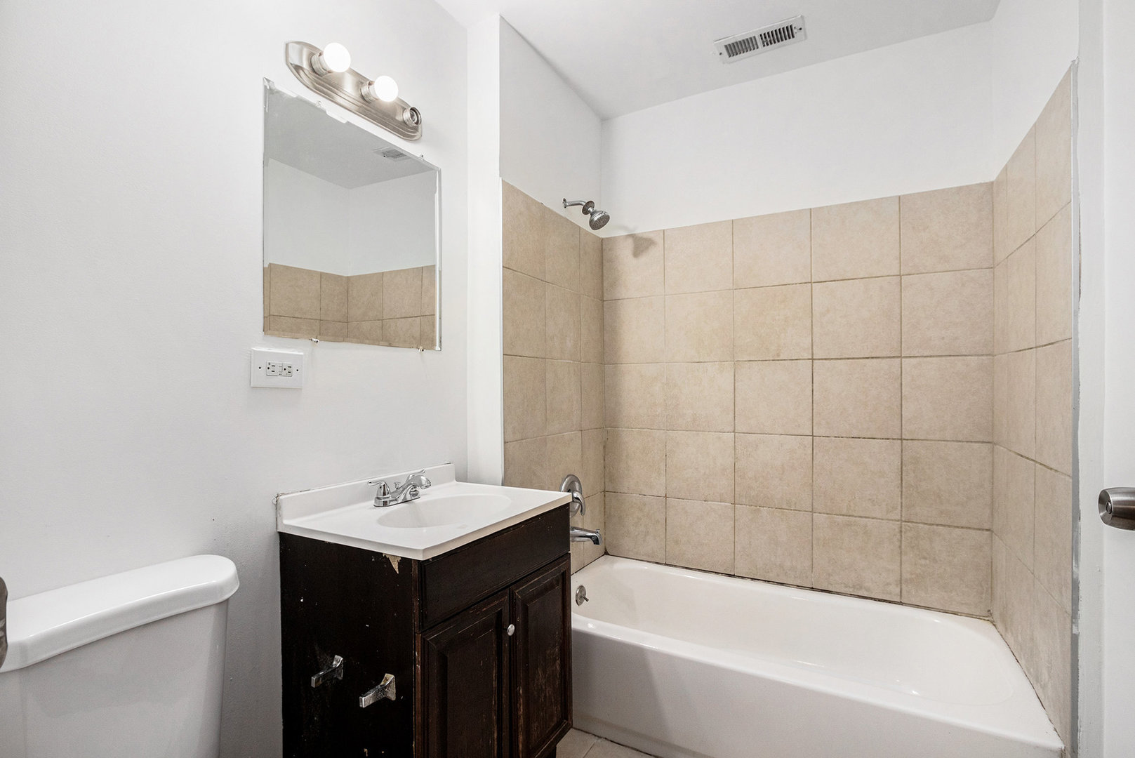 17153 Burnham Avenue Lansing, IL 60438 - Photo 15 of 18 a bathroom with a bathtub a sink a vanity and a shower