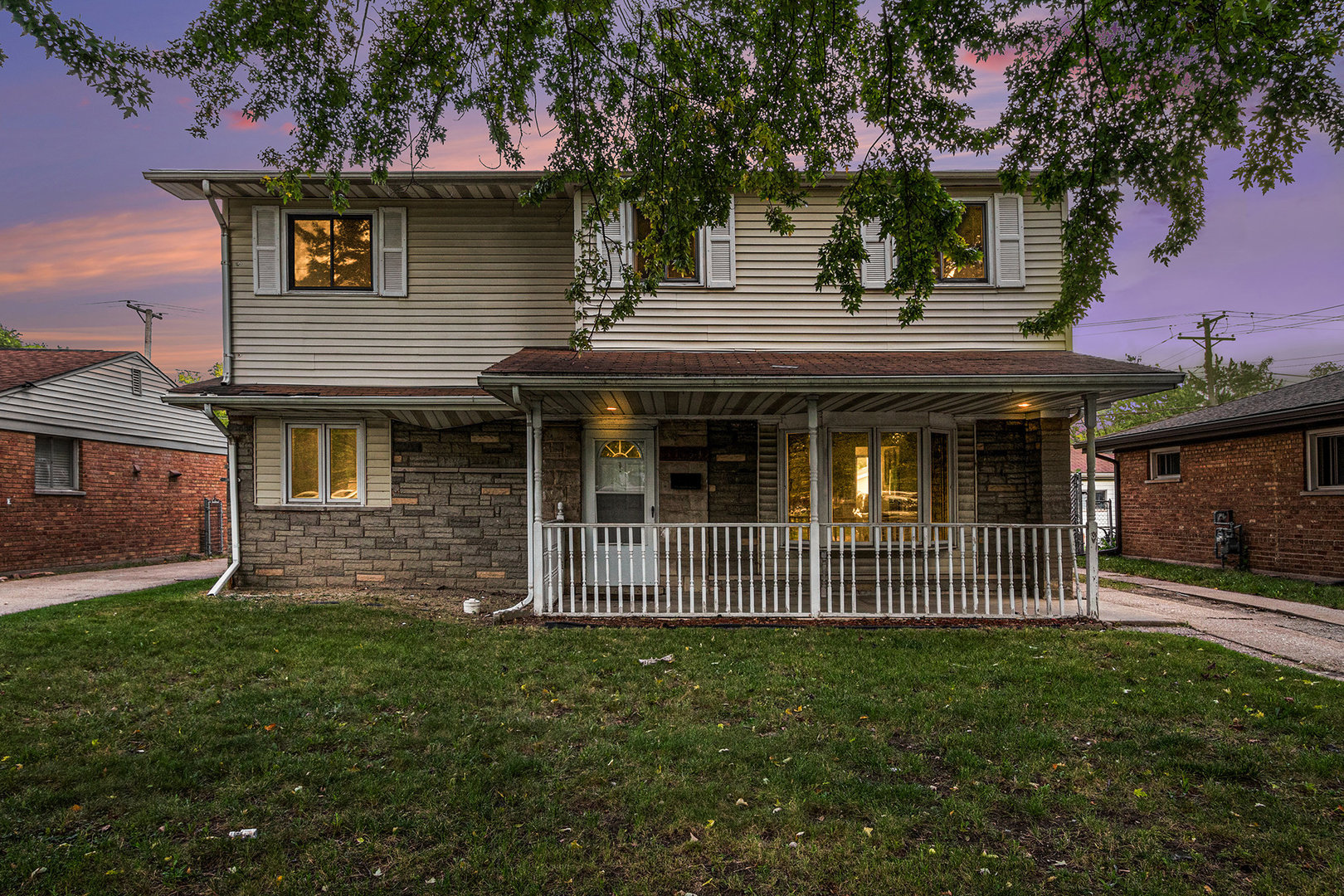 17153 Burnham Avenue Lansing, IL 60438 - Photo 2 of 18 a front view of a house with garden