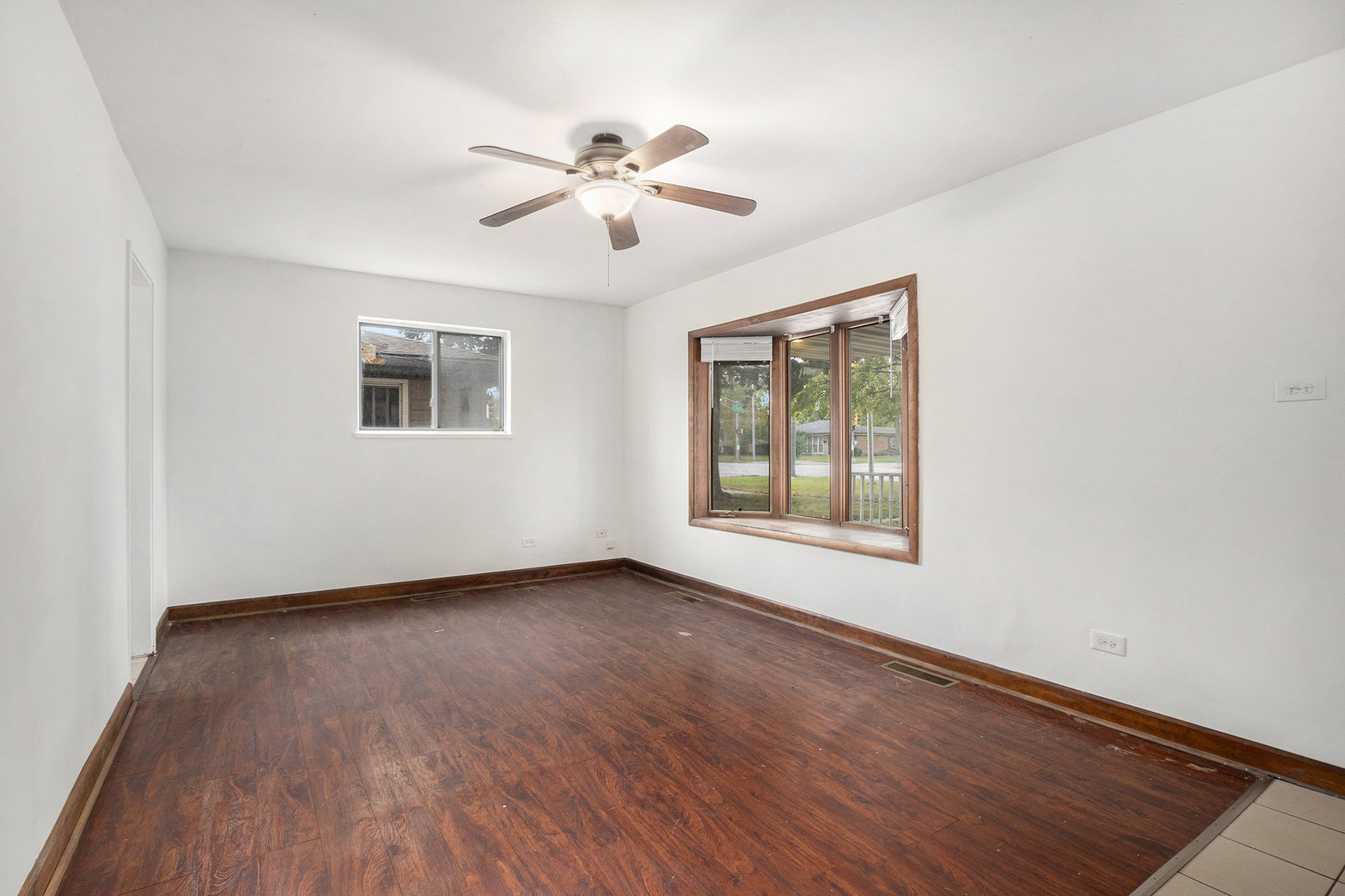 17153 Burnham Avenue Lansing, IL 60438 - Photo 4 of 18 a view of an empty room with wooden floor and a window