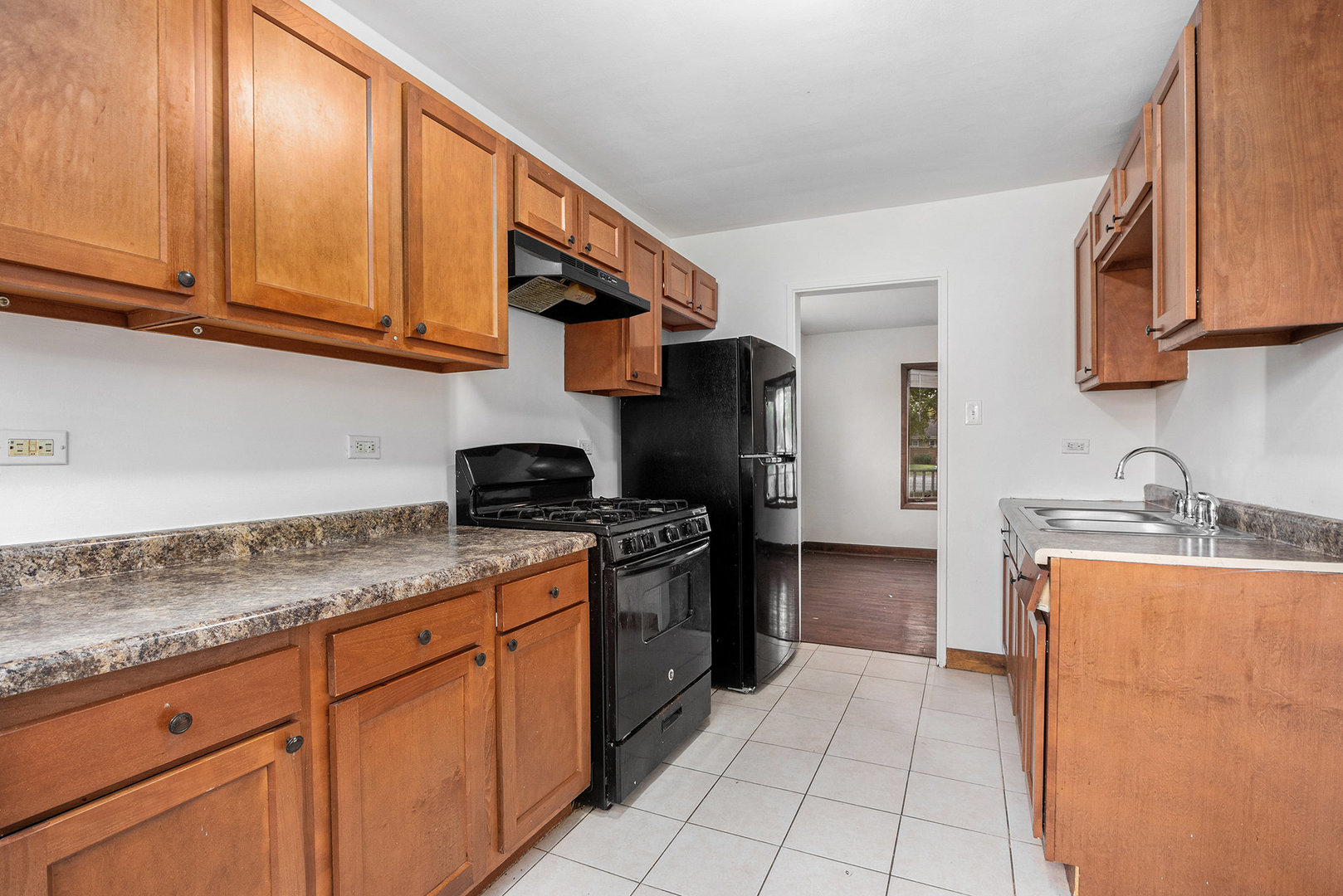 17153 Burnham Avenue Lansing, IL 60438 - Photo 7 of 18 a kitchen with stainless steel appliances granite countertop a sink stove and cabinets