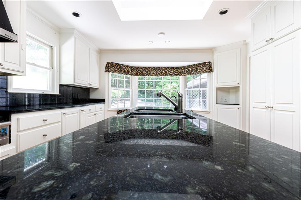 4765 Paran Valley Northwest Atlanta, GA 30327 - Photo 24 of 61 a kitchen with granite countertop a stove and a refrigerator