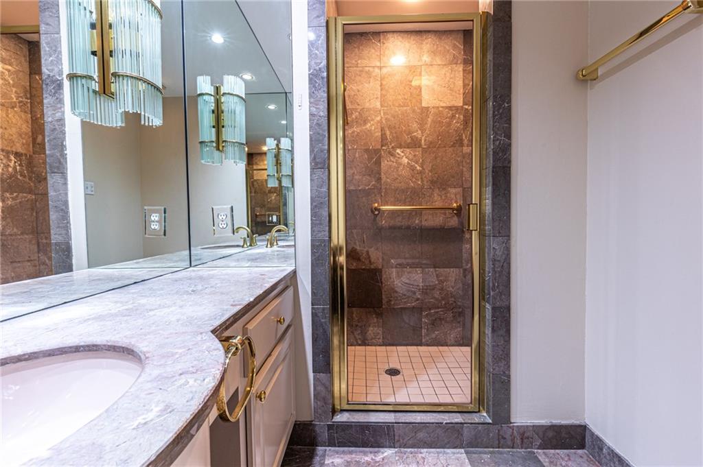 4765 Paran Valley Northwest Atlanta, GA 30327 - Photo 28 of 61 a bathroom with a granite countertop shower a sink and a mirror