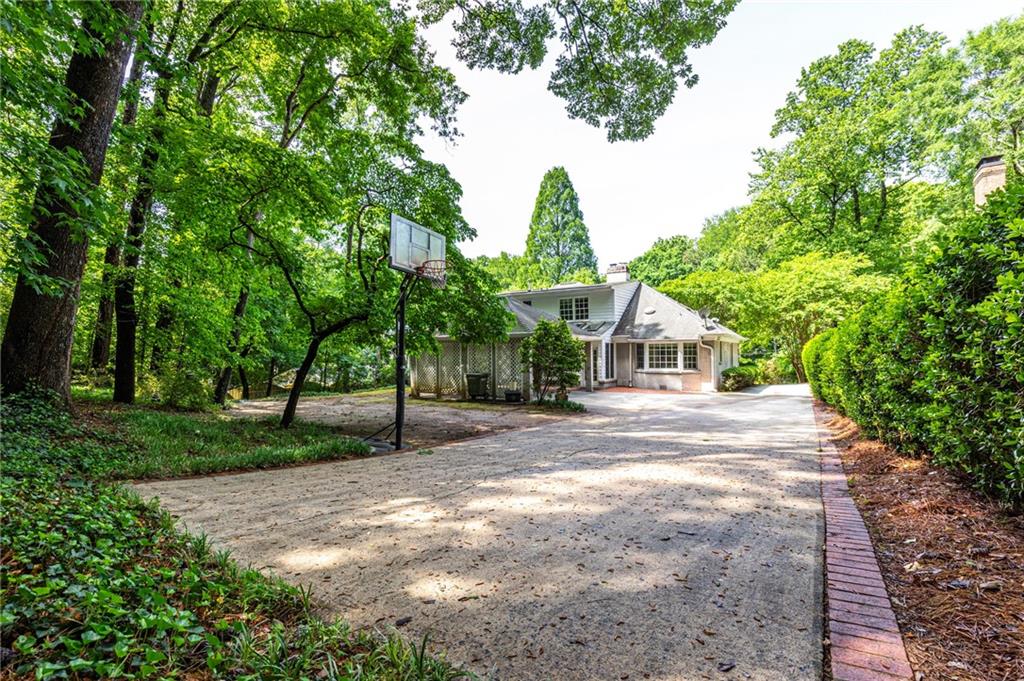 4765 Paran Valley Northwest Atlanta, GA 30327 - Photo 3 of 61 a front view of a house with a yard and trees