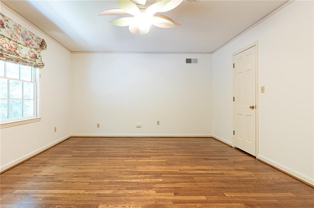 4765 Paran Valley Northwest Atlanta, GA 30327 - Photo 49 of 61 an empty room with wooden floor and windows