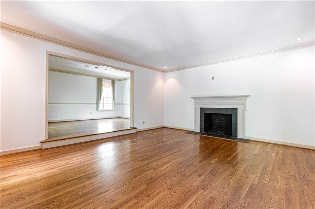 4765 Paran Valley Northwest Atlanta, GA 30327 - Photo 10 of 61 a view of empty room with wooden floor and fireplace
