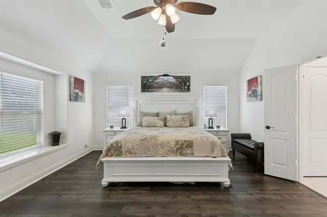 a spacious bedroom with a bed and a window