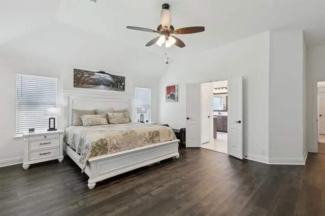 a bedroom with a bed and a ceiling fan