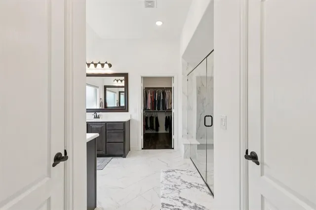 a bathroom with a double vanity sink mirror and