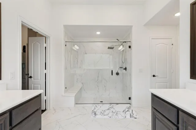 a bathroom with a double vanity sink and mirror