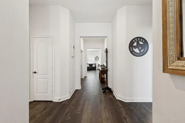 a view of hallway with wooden floor