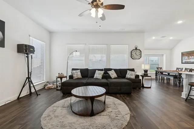 a living room with furniture and a wooden floor