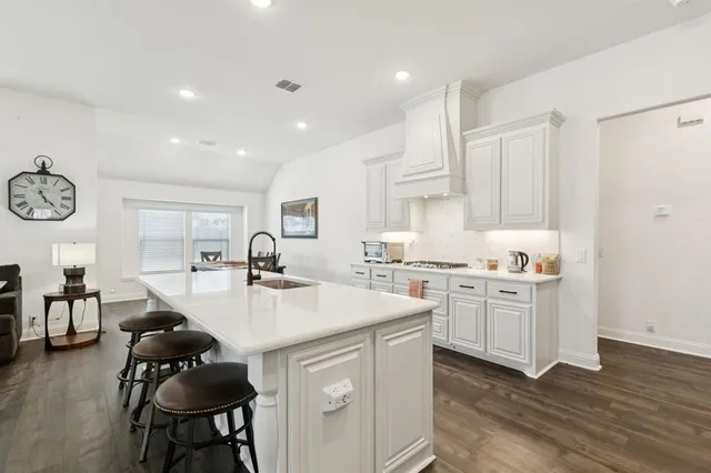 a kitchen with sink cabinets and wooden floor