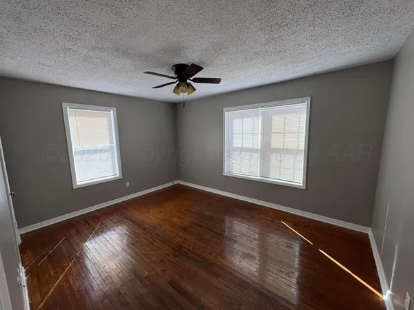 a view of an empty room with windows