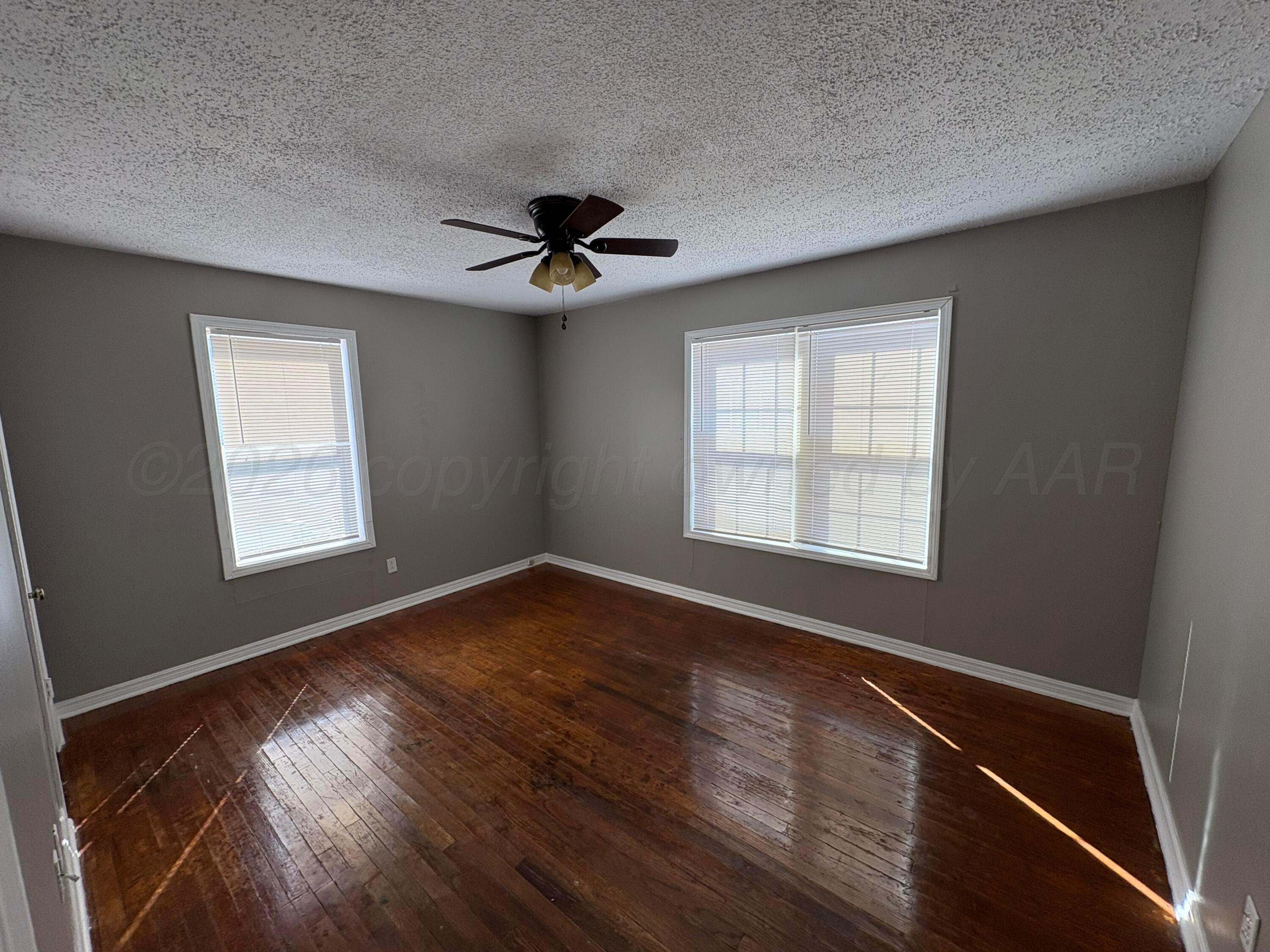 4119 Parker Street Amarillo, TX 79110 - Photo 5 of 8 a view of an empty room with windows