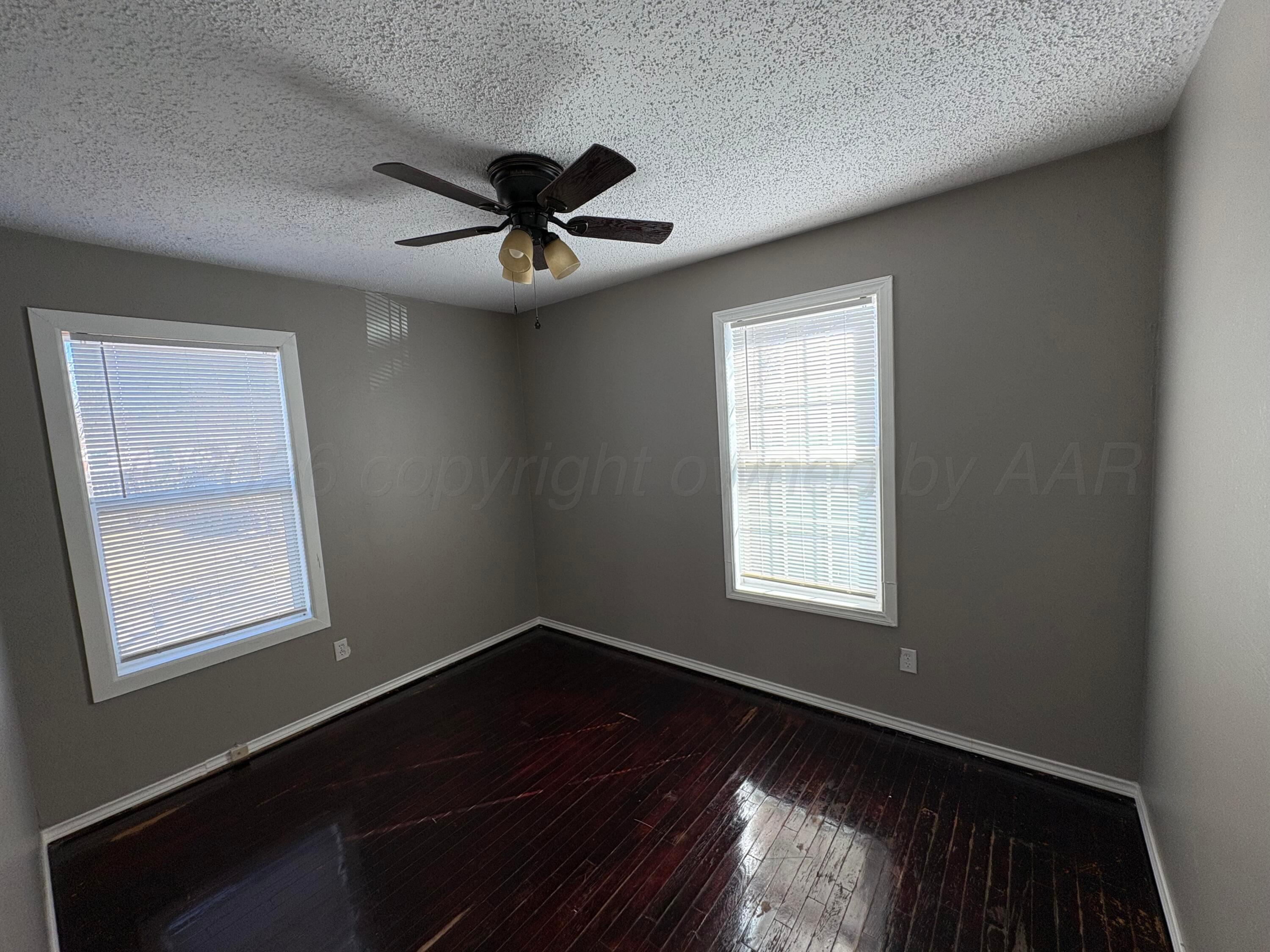 4119 Parker Street Amarillo, TX 79110 - Photo 6 of 8 a view of empty room with windows