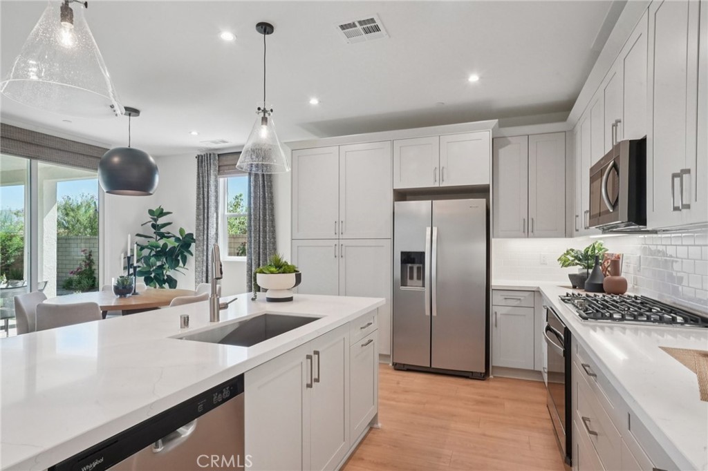 73525 Raphael Drive Palm Desert, CA 92211 - Photo 11 of 41 a kitchen with refrigerator cabinets and a sink