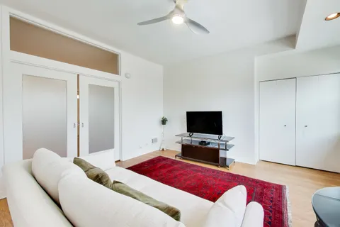 a bedroom with a bed and painting on the wall
