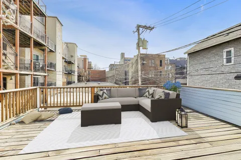 a view of balcony with wooden floor and floor to ceiling window