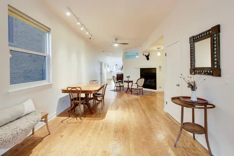 a view of a livingroom with furniture hardwood floor and workspace