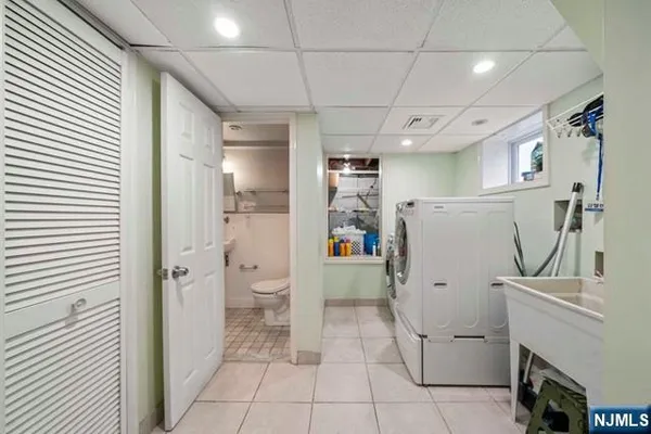 a view of a storage & utility room with closet dryer and washer