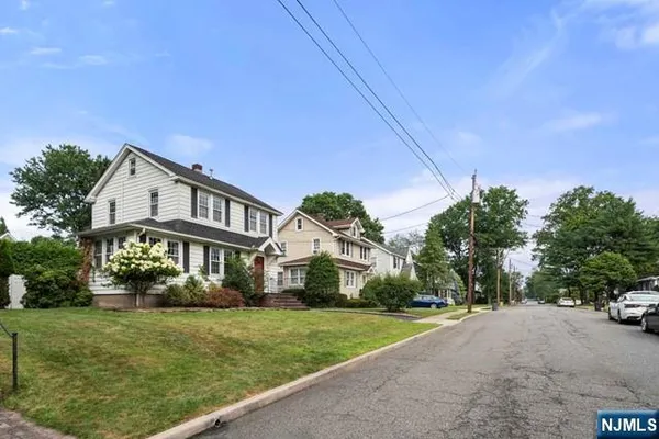 a view of a house with a yard and potted plants