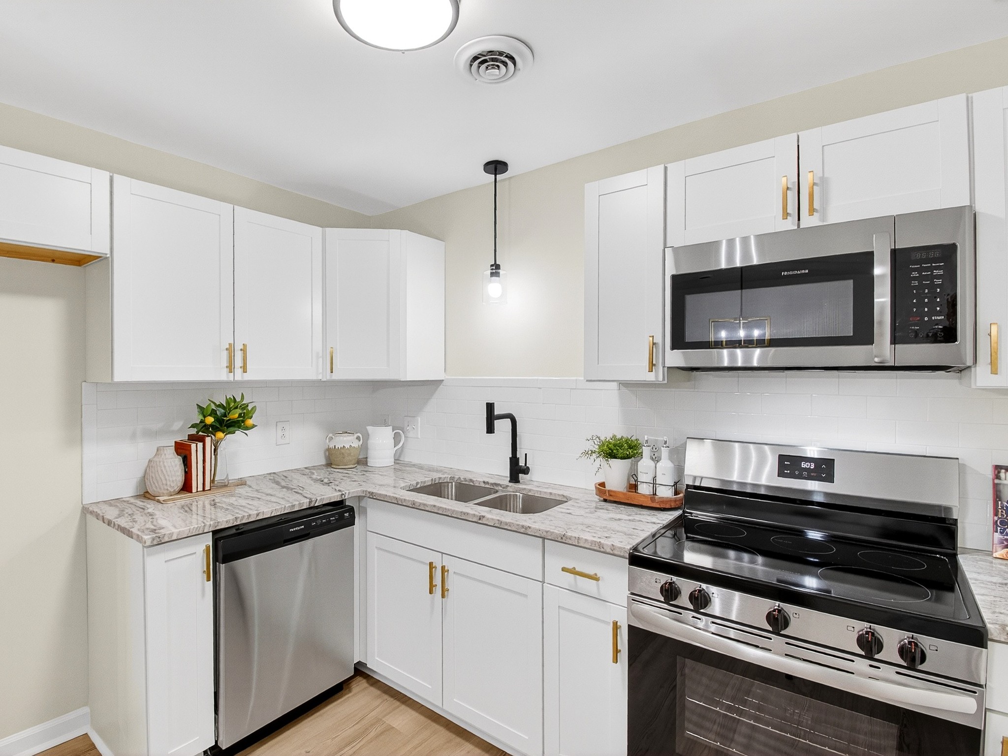 159 Hicks Road Nashville, TN 37221 - Photo 15 of 46 a kitchen with stainless steel appliances a stove a microwave a sink and cabinets