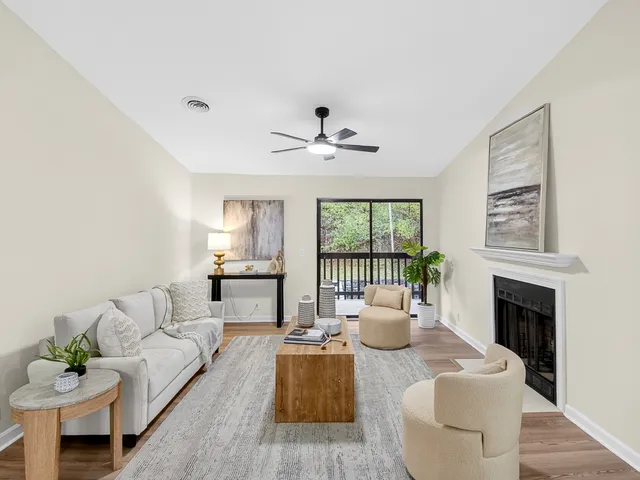 a living room with furniture a fireplace and a table