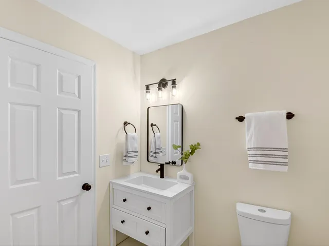 a bathroom with a sink vanity and mirror
