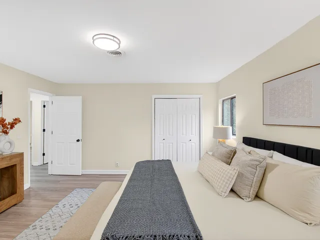 a bedroom with a bed and a couch