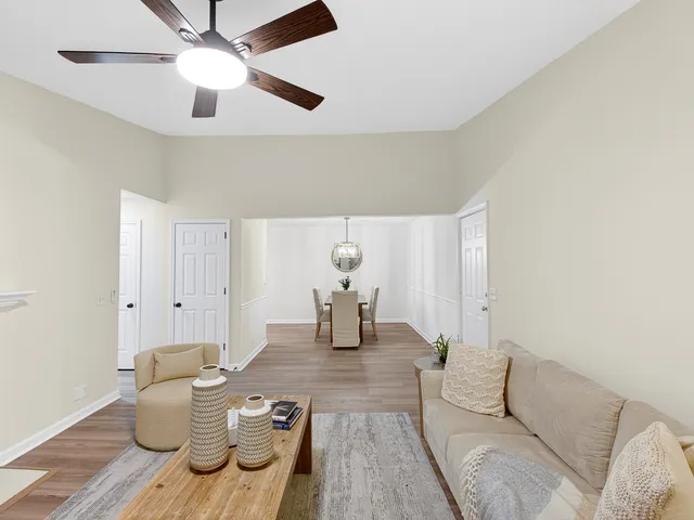 a living room with furniture and wooden floor