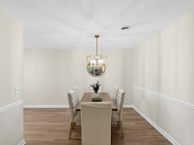 a dining room with furniture and wooden floor
