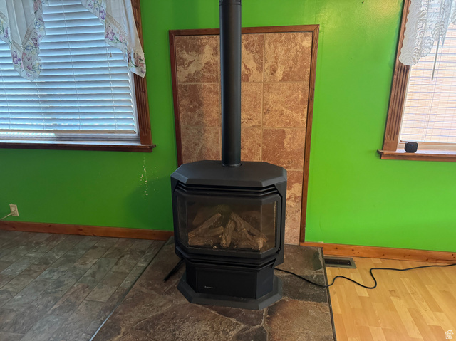 210 South State Street Moroni, UT 84646 - Photo 4 of 23 Freestanding black fireplace with a glass viewing door and visible logs