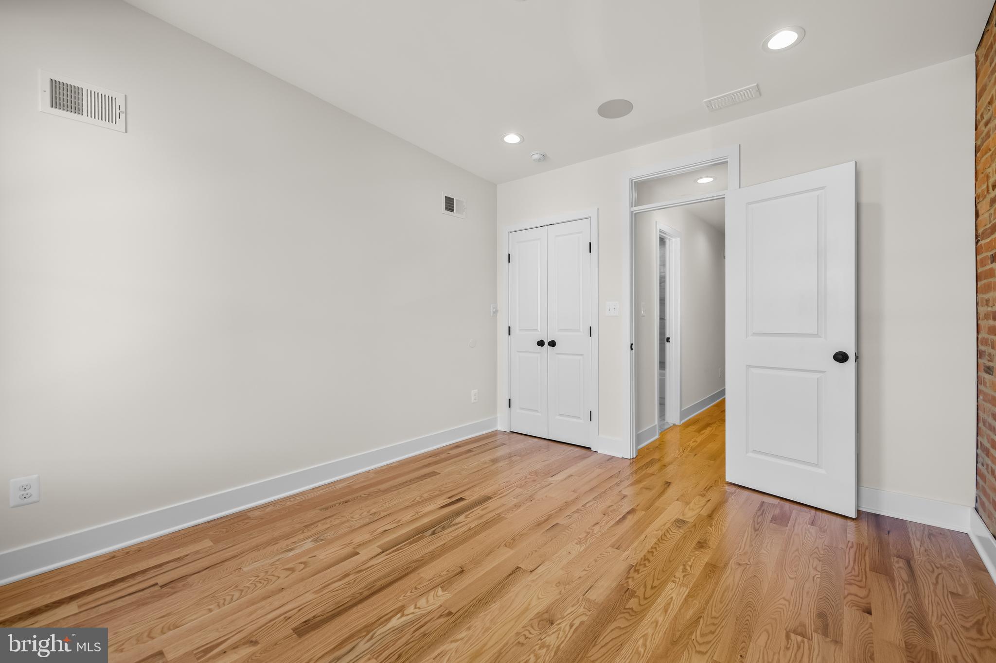 1317 Webster Street Baltimore, MD 21230 - Photo 18 of 32 a view of an empty room with wooden floor