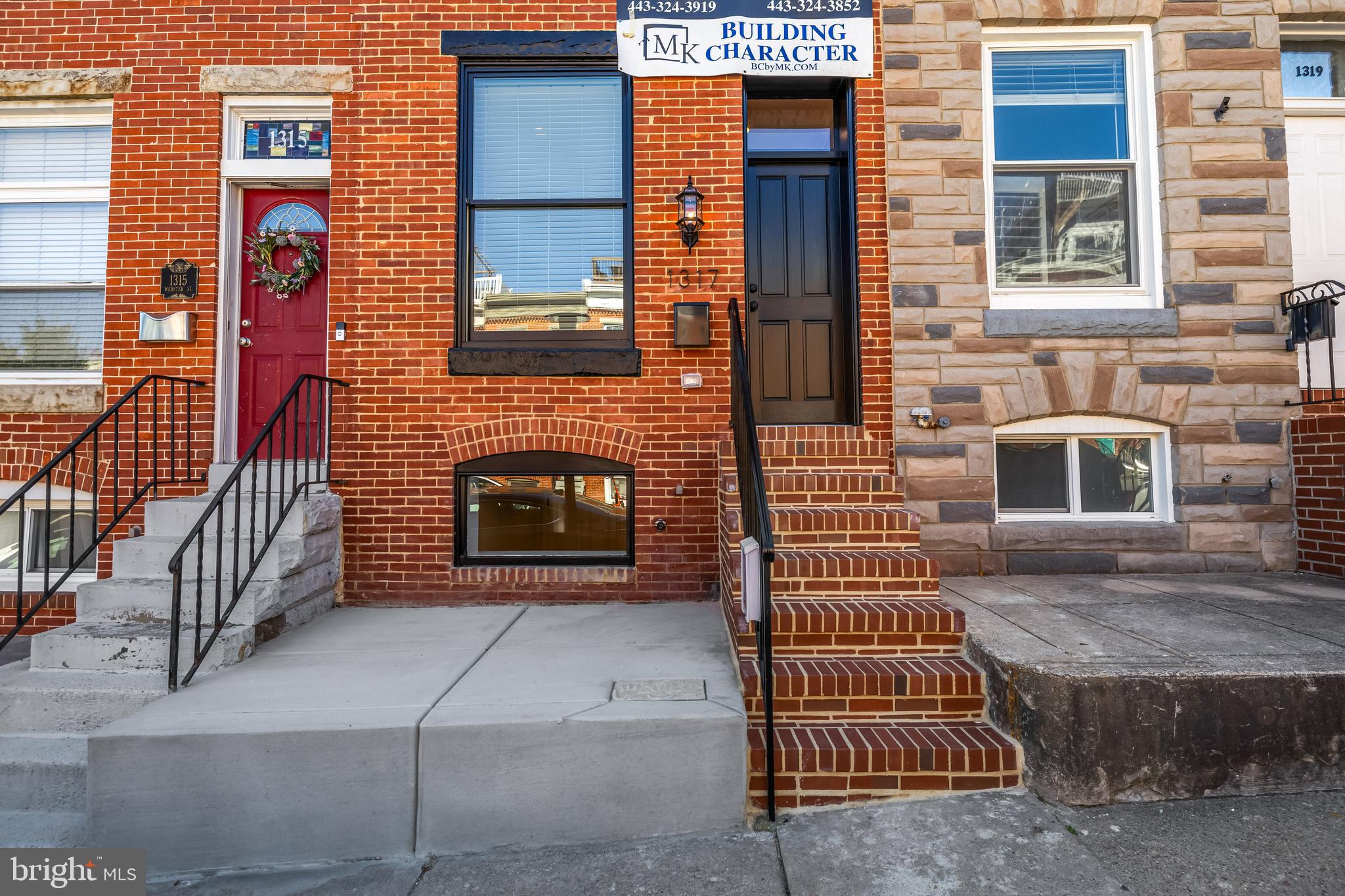 1317 Webster Street Baltimore, MD 21230 - Photo 2 of 32 a front view of a house with a yard