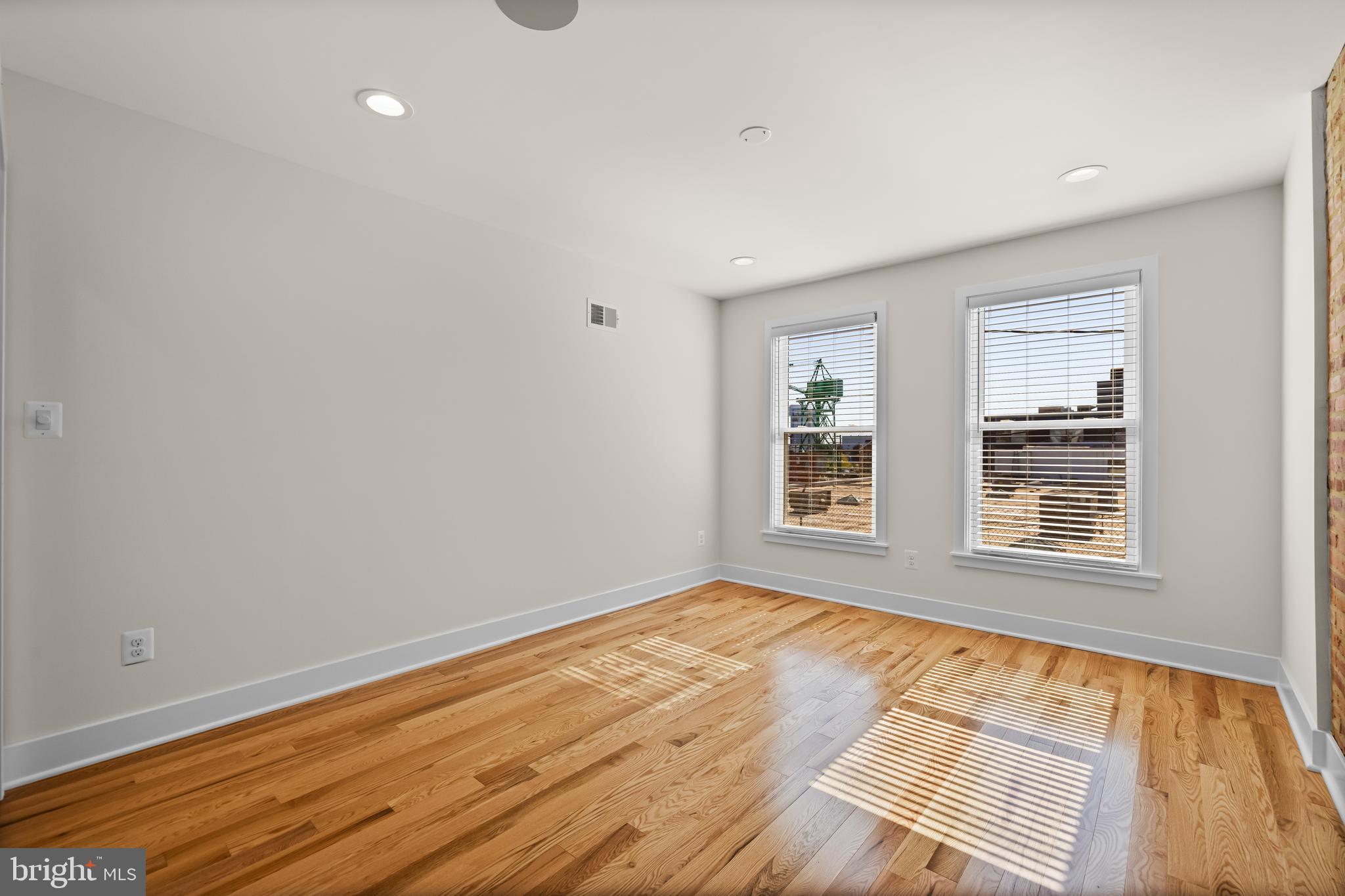 1317 Webster Street Baltimore, MD 21230 - Photo 21 of 32 a view of an empty room with wooden floor and a window