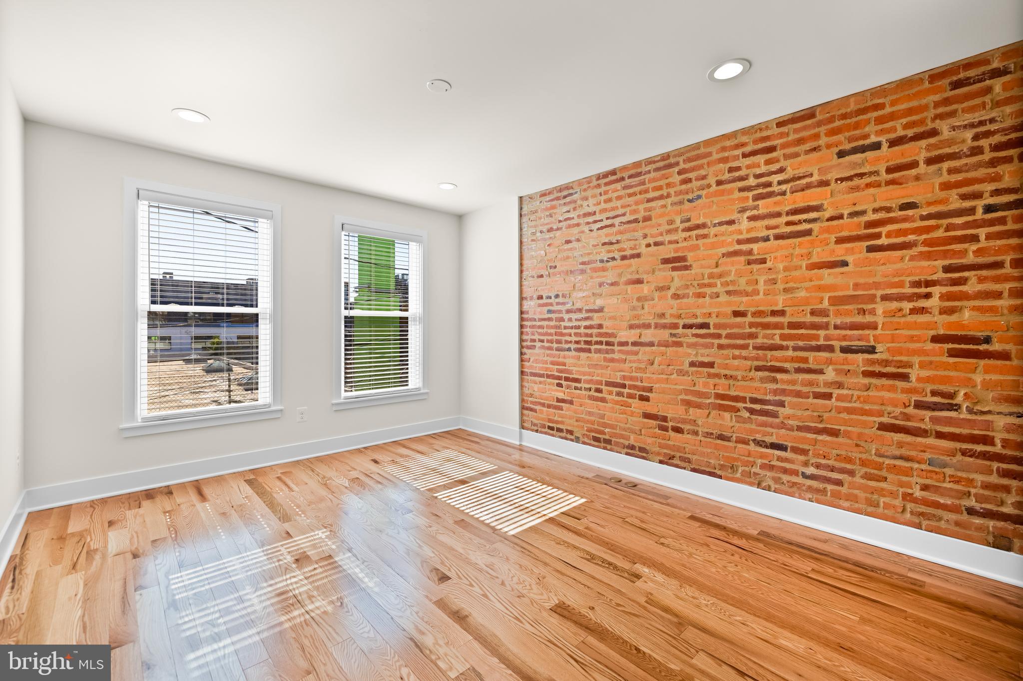 1317 Webster Street Baltimore, MD 21230 - Photo 22 of 32 a view of an empty room with wooden floor and a window