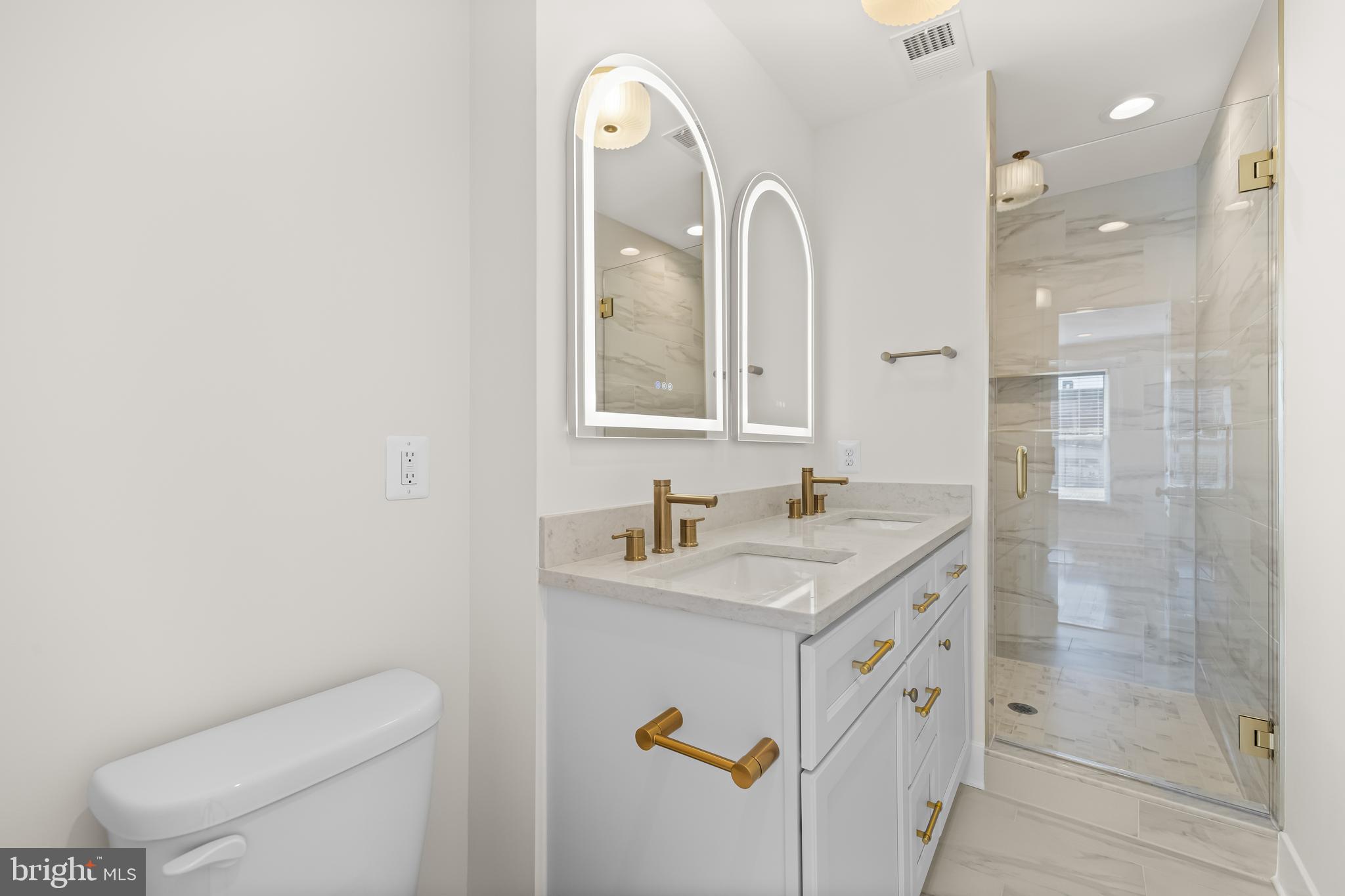 1317 Webster Street Baltimore, MD 21230 - Photo 24 of 32 a bathroom with a sink a toilet a mirror and shower