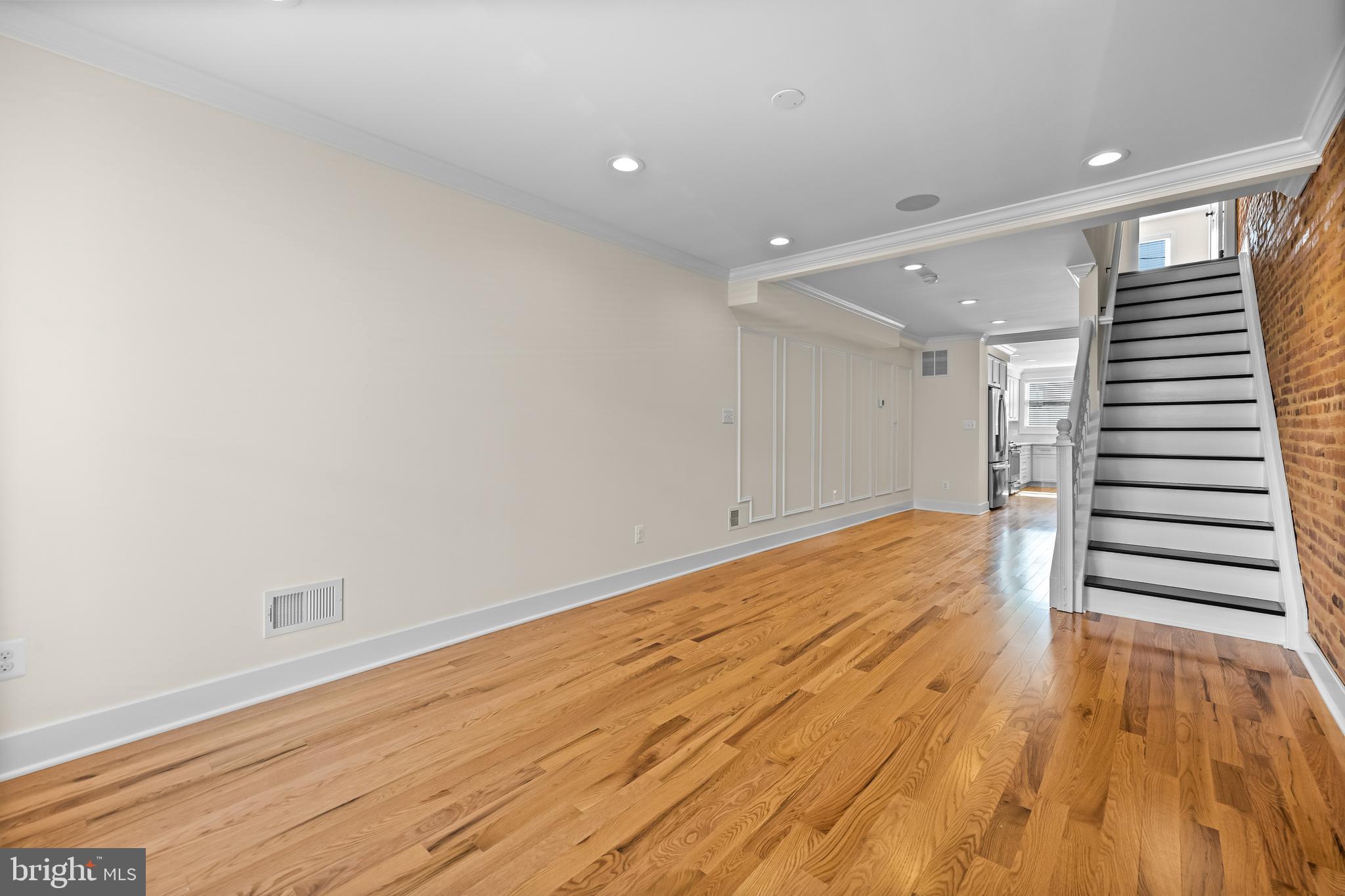 1317 Webster Street Baltimore, MD 21230 - Photo 3 of 32 a view of a room with wooden floor and stairs
