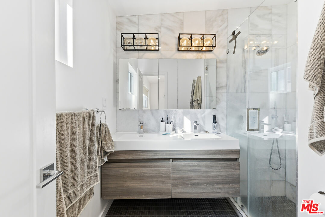 2603 Abbot Kinney Boulevard, Unit 1/2 Venice, CA 90291 - Photo 11 of 16 a bathroom with a sink a mirror and shower