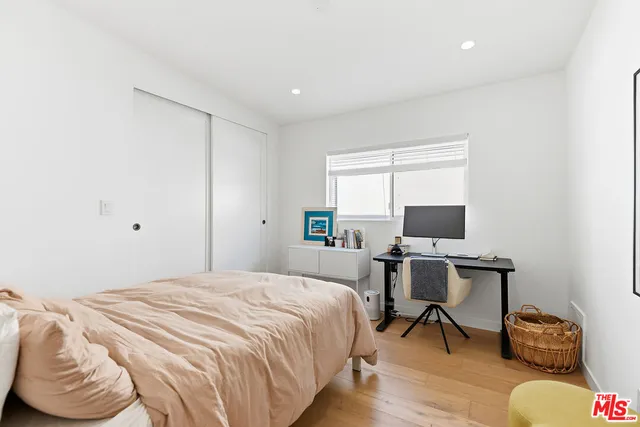 a bedroom with a bed and a desk