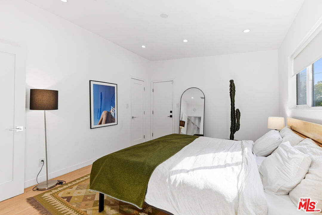 2603 Abbot Kinney Boulevard, Unit 1/2 Venice, CA 90291 - Photo 10 of 16 a bedroom with a bed and a flat screen tv