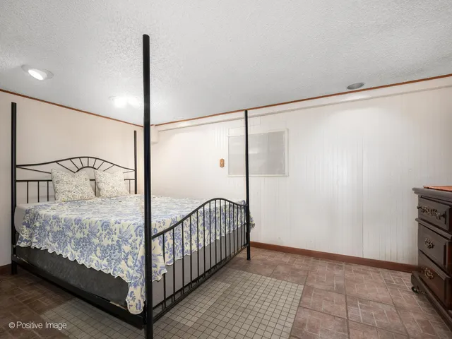 a bedroom with a bed and a ceiling fan