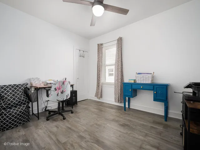 a bedroom with furniture and a wooden floor