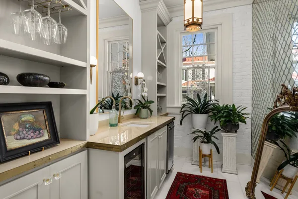 a living room with furniture a bookshelf and a wooden floor