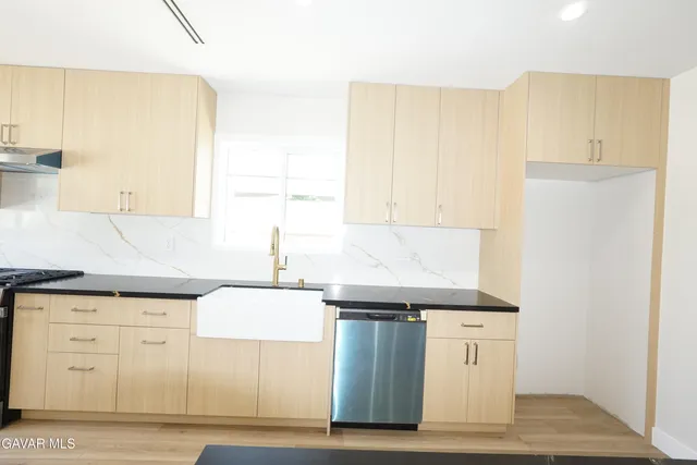a bathroom with a granite countertop sink a toilet and shower
